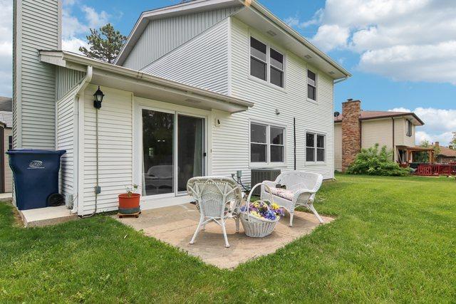 104 S Walnut Ln, Schaumburg, IL 60193 - rear view of property with a lawn, a chimney, and a patio area