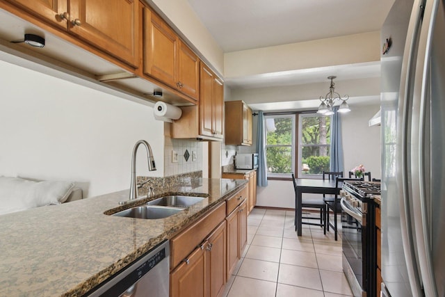 104 S Walnut Ln, Schaumburg, IL 60193 - kitchen featuring appliances with stainless steel finishes, a sink, brown cabinetry, backsplash, and light tile patterned floors