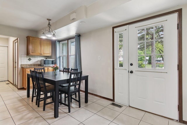 104 S Walnut Ln, Schaumburg, IL 60193 - dining space with plenty of natural light, light tile patterned floors, and baseboards