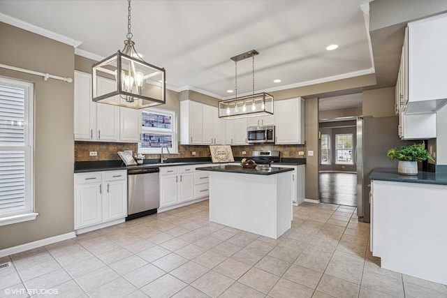 6 Valhalla Ct, Lake In The Hills, IL 60156 - kitchen with appliances with stainless steel finishes, backsplash, a center island, dark countertops, and crown molding