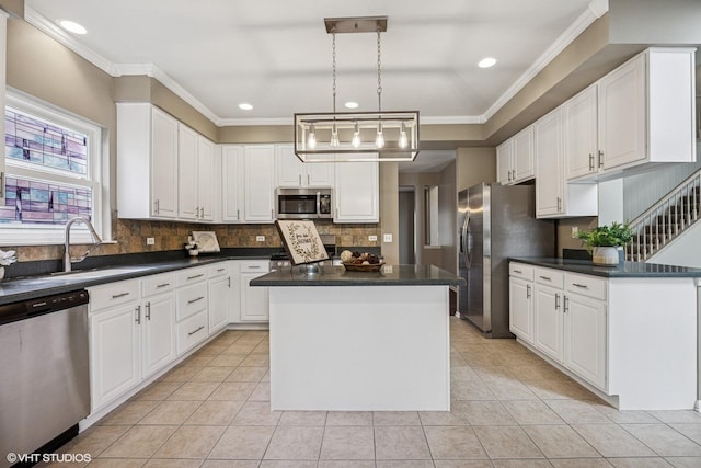 6 Valhalla Ct, Lake In The Hills, IL 60156 - kitchen with appliances with stainless steel finishes, a kitchen island, dark countertops, white cabinets, and crown molding