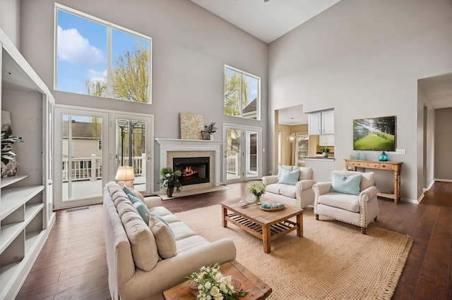 6 Valhalla Ct, Lake In The Hills, IL 60156 - living room featuring a high ceiling, hardwood / wood-style flooring, plenty of natural light, a fireplace with flush hearth, and baseboards