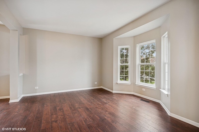 6 Valhalla Ct, Lake In The Hills, IL 60156 - empty room featuring dark wood-type flooring and baseboards