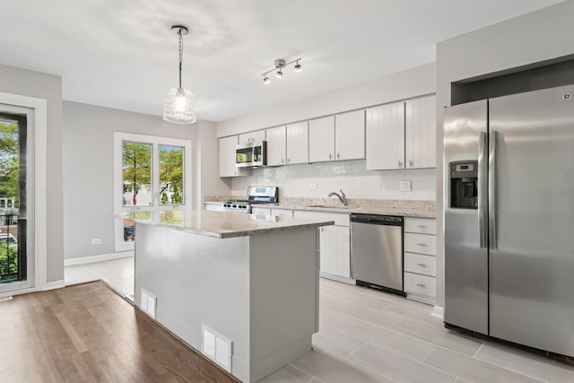 2717 S Michigan Ave, Chicago, IL 60616 - kitchen featuring stainless steel appliances, healthy amount of natural light, a sink, and a center island