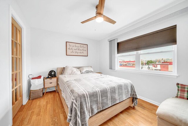3907 N Harlem Ave Unit 304B, Chicago, IL 60634 - bedroom featuring wood finished floors, baseboards, and ceiling fan