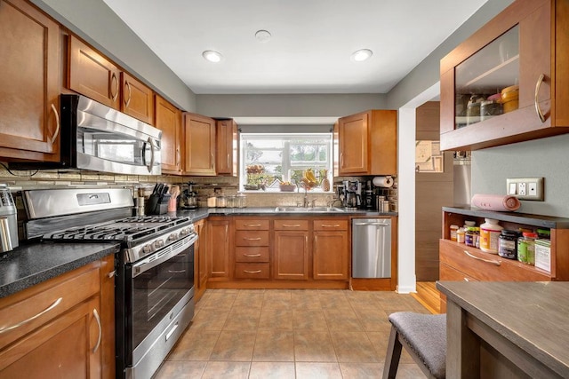 3907 N Harlem Ave Unit 304B, Chicago, IL 60634 - kitchen with stainless steel appliances, tasteful backsplash, brown cabinetry, and recessed lighting