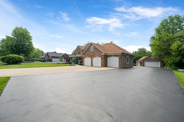 6099 Polo Club Dr, Yorkville, IL 60560 - view of front of property featuring brick siding, a front yard, a garage, and asphalt driveway