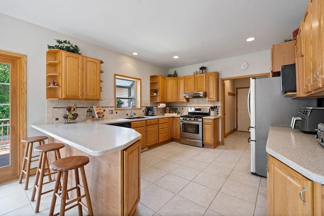6099 Polo Club Dr, Yorkville, IL 60560 - kitchen with open shelves, stainless steel gas stove, under cabinet range hood, a peninsula, and healthy amount of natural light