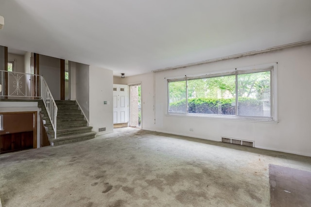 1808 Laurel Ave, Evanston, IL 60201 - unfurnished living room with stairs, carpet, and baseboards
