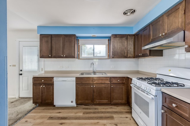 1808 Laurel Ave, Evanston, IL 60201 - kitchen with white appliances, a sink, exhaust hood, light countertops, and backsplash