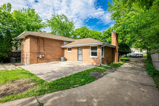 1808 Laurel Ave, Evanston, IL 60201 - rear view of property with a chimney, brick siding, and a patio