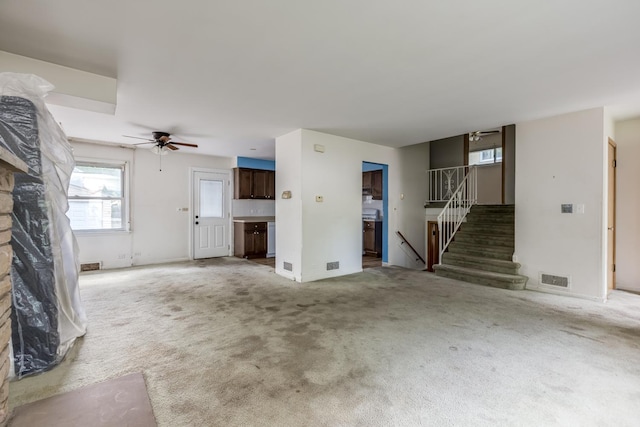 1808 Laurel Ave, Evanston, IL 60201 - unfurnished living room with stairway, ceiling fan, light colored carpet, and baseboards