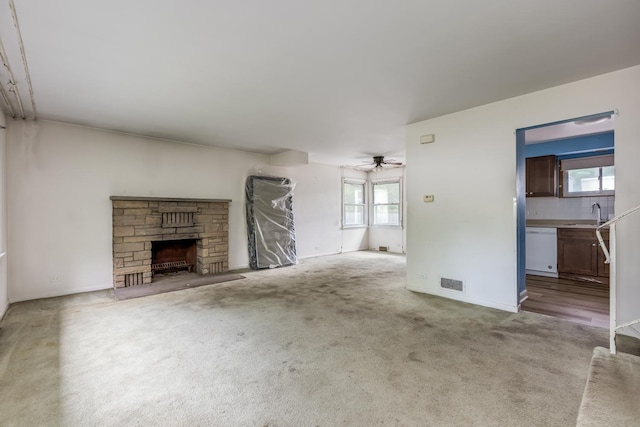 1808 Laurel Ave, Evanston, IL 60201 - unfurnished living room featuring a ceiling fan, carpet floors, a fireplace, a sink, and baseboards