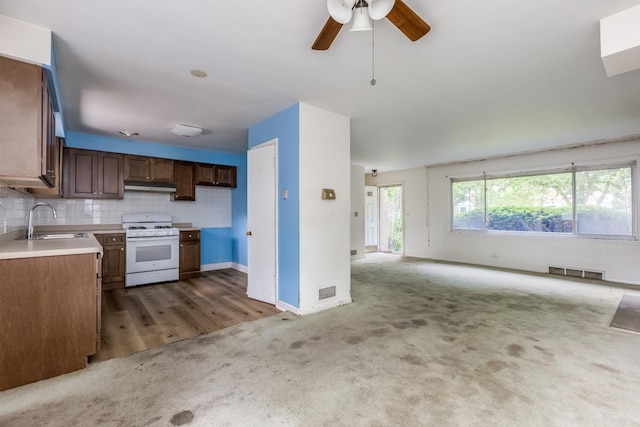 1808 Laurel Ave, Evanston, IL 60201 - kitchen featuring white gas stove, a sink, carpet, open floor plan, and ceiling fan