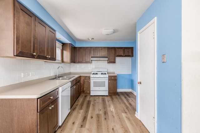 1808 Laurel Ave, Evanston, IL 60201 - kitchen with white appliances, a sink, under cabinet range hood, and decorative backsplash