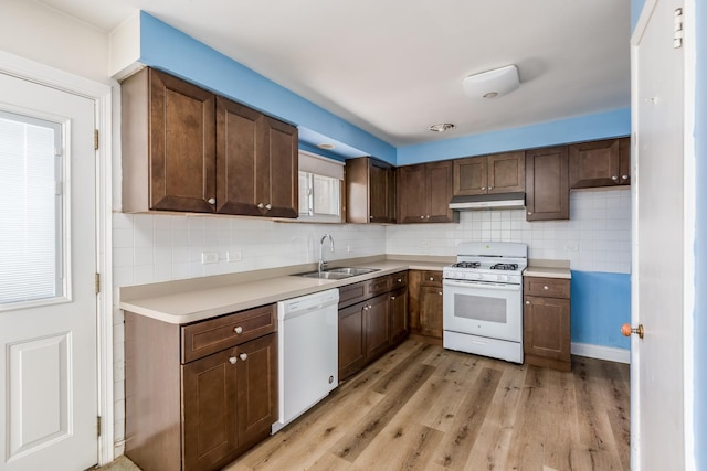 1808 Laurel Ave, Evanston, IL 60201 - kitchen with white appliances, under cabinet range hood, a sink, decorative backsplash, and light countertops