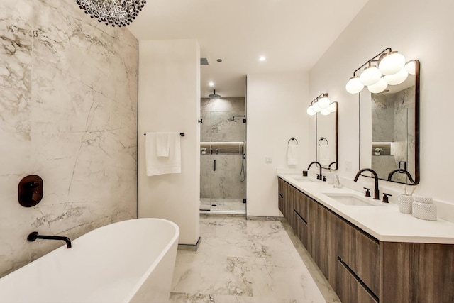 613 N Ogden Ave Unit 4W, Chicago, IL 60642 - bathroom featuring a stall shower, marble tiled floors, a soaking tub, double vanity, and recessed lighting