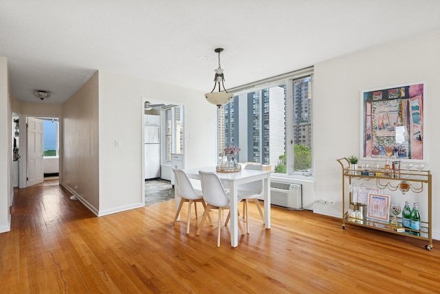 1400 N State Pkwy Unit 9F, Chicago, IL 60610 - dining room featuring light wood-style flooring and a wall mounted air conditioner