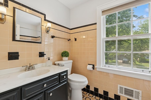 8335 Kostner Ave, Skokie, IL 60076 - bathroom with tile walls, vanity, toilet, and tile patterned floors
