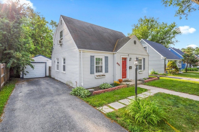 475 S Edison Ave, Elgin, IL 60123 - cape cod home with a detached garage, an outbuilding, roof with shingles, a front lawn, and driveway