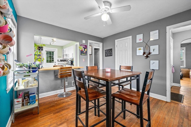 475 S Edison Ave, Elgin, IL 60123 - dining space featuring wood-type flooring, ceiling fan, and arched walkways