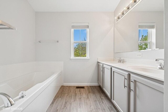 2746 Middleton Ct, Aurora, IL 60503 - full bath with double vanity, a bath, baseboards, and wood finished floors