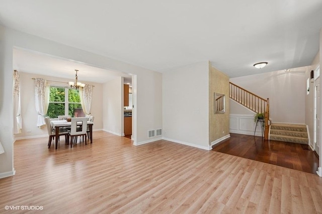 2746 Middleton Ct, Aurora, IL 60503 - living area featuring a chandelier, wood finished floors, stairs, and baseboards