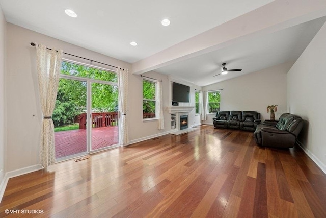 2746 Middleton Ct, Aurora, IL 60503 - living room with wood finished floors, baseboards, a lit fireplace, lofted ceiling, and a ceiling fan