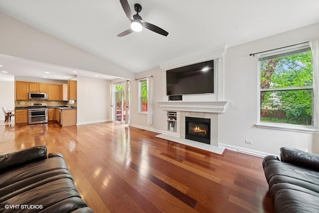 2746 Middleton Ct, Aurora, IL 60503 - living room with a tiled fireplace, plenty of natural light, lofted ceiling, light wood-type flooring, and ceiling fan