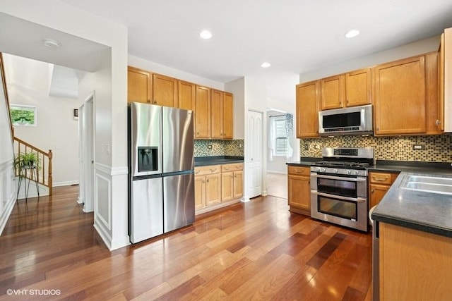 2746 Middleton Ct, Aurora, IL 60503 - kitchen featuring stainless steel appliances, dark countertops, dark wood finished floors, backsplash, and recessed lighting