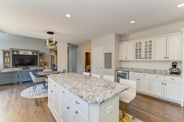 6205 Brookridge Dr, Plainfield, IL 60586 - kitchen featuring wine cooler, dark wood-type flooring, white cabinetry, a center island, and a kitchen breakfast bar
