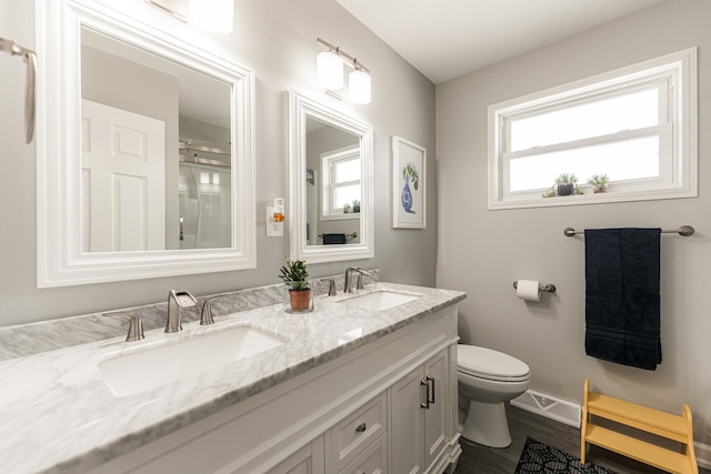 7141 W 72nd St, Chicago, IL 60638 - full bathroom with double vanity and wood finished floors