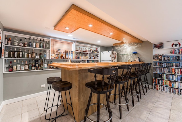 7141 W 72nd St, Chicago, IL 60638 - indoor dry bar with freestanding refrigerator, tile patterned flooring, and recessed lighting