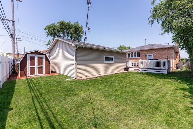 7141 W 72nd St, Chicago, IL 60638 - rear view of house featuring a fenced backyard, a storage unit, and a deck