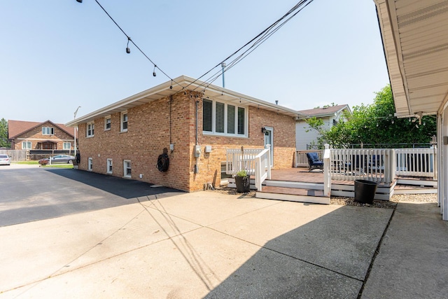 7141 W 72nd St, Chicago, IL 60638 - rear view of property featuring brick siding and a wooden deck