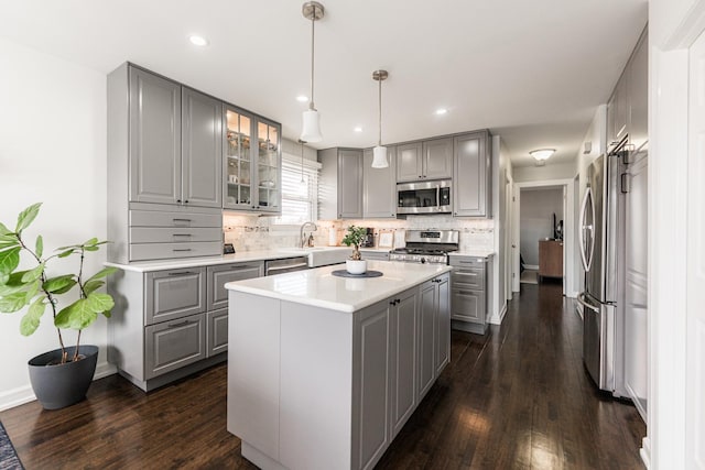 7141 W 72nd St, Chicago, IL 60638 - kitchen featuring gray cabinets, stainless steel appliances, glass insert cabinets, tasteful backsplash, and dark wood finished floors