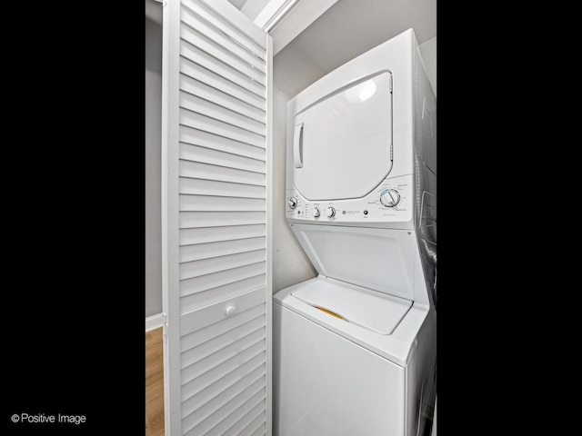 1632 S Indiana Ave Unit 304, Chicago, IL 60616 - washroom featuring stacked washer and clothes dryer and wood finished floors