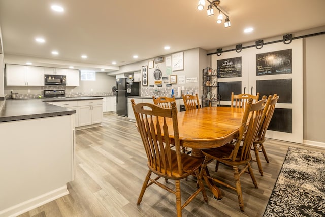 608 Cherry Tree Ln, Genoa, IL 60135 - dining space featuring light wood-type flooring, bar, and recessed lighting