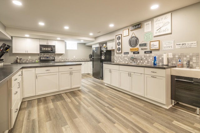 608 Cherry Tree Ln, Genoa, IL 60135 - kitchen with black appliances, dark countertops, backsplash, light wood-style floors, and recessed lighting