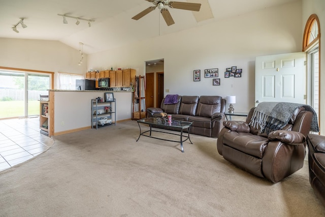 608 Cherry Tree Ln, Genoa, IL 60135 - living room featuring track lighting, light colored carpet, a ceiling fan, high vaulted ceiling, and baseboards