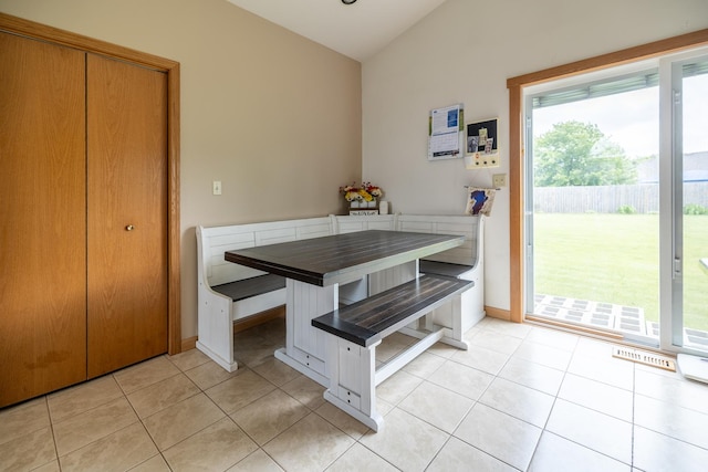 608 Cherry Tree Ln, Genoa, IL 60135 - dining area with breakfast area, light tile patterned floors, lofted ceiling, and baseboards