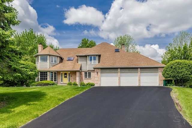 181 N Meadowlark Dr, Hawthorn Woods, IL 60047 - view of front of property featuring a chimney, a garage, driveway, and brick siding