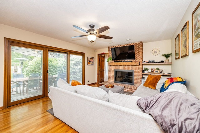 181 N Meadowlark Dr, Hawthorn Woods, IL 60047 - living area featuring light wood-style floors, a brick fireplace, and a ceiling fan