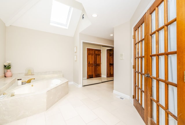 181 N Meadowlark Dr, Hawthorn Woods, IL 60047 - full bath featuring a skylight, a bath, french doors, tile patterned flooring, and baseboards