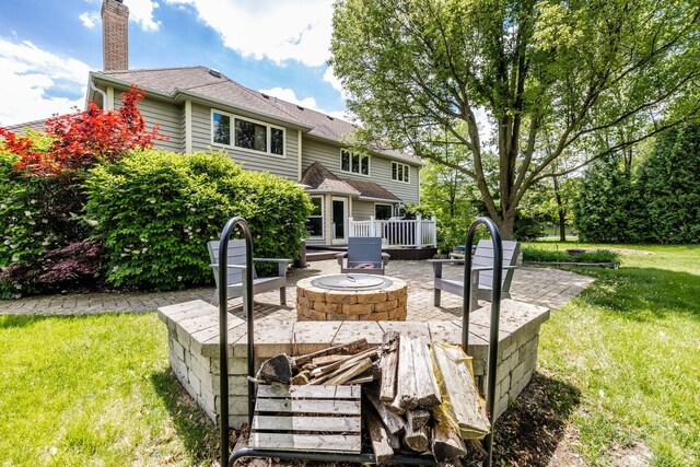 181 N Meadowlark Dr, Hawthorn Woods, IL 60047 - back of house with an outdoor fire pit, a yard, a chimney, a patio, and a wooden deck