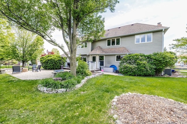 181 N Meadowlark Dr, Hawthorn Woods, IL 60047 - back of property with a patio area, a yard, a chimney, and a shingled roof
