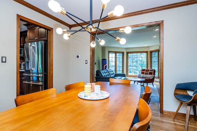 181 N Meadowlark Dr, Hawthorn Woods, IL 60047 - dining space with crown molding, a chandelier, wood finished floors, and baseboards