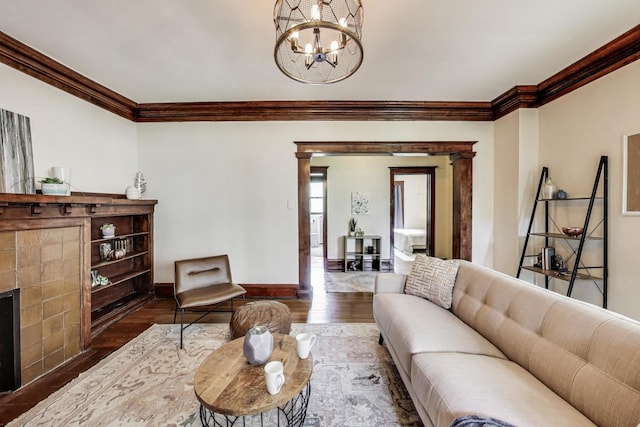 5520 S Cornell Ave Unit 1S, Chicago, IL 60637 - living room with ornamental molding, a chandelier, wood finished floors, and a tiled fireplace
