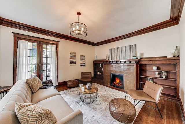 5520 S Cornell Ave Unit 1S, Chicago, IL 60637 - living area featuring wood finished floors, ornamental molding, a tile fireplace, and a chandelier