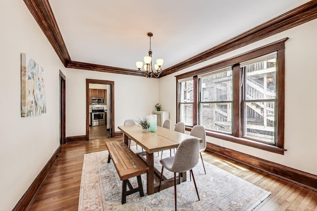 5520 S Cornell Ave Unit 1S, Chicago, IL 60637 - dining room featuring ornamental molding, a chandelier, and dark wood-style floors